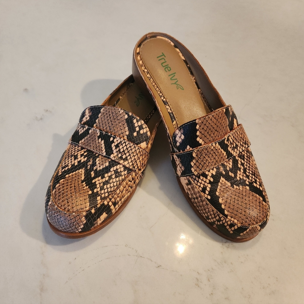 Faux snakeskin slip on shoes.